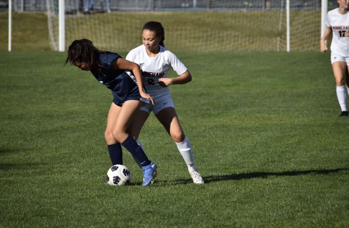 WIN THE BATTLE. Freshman Ariella Kim fights for the ball against a Minnehaha player. 

